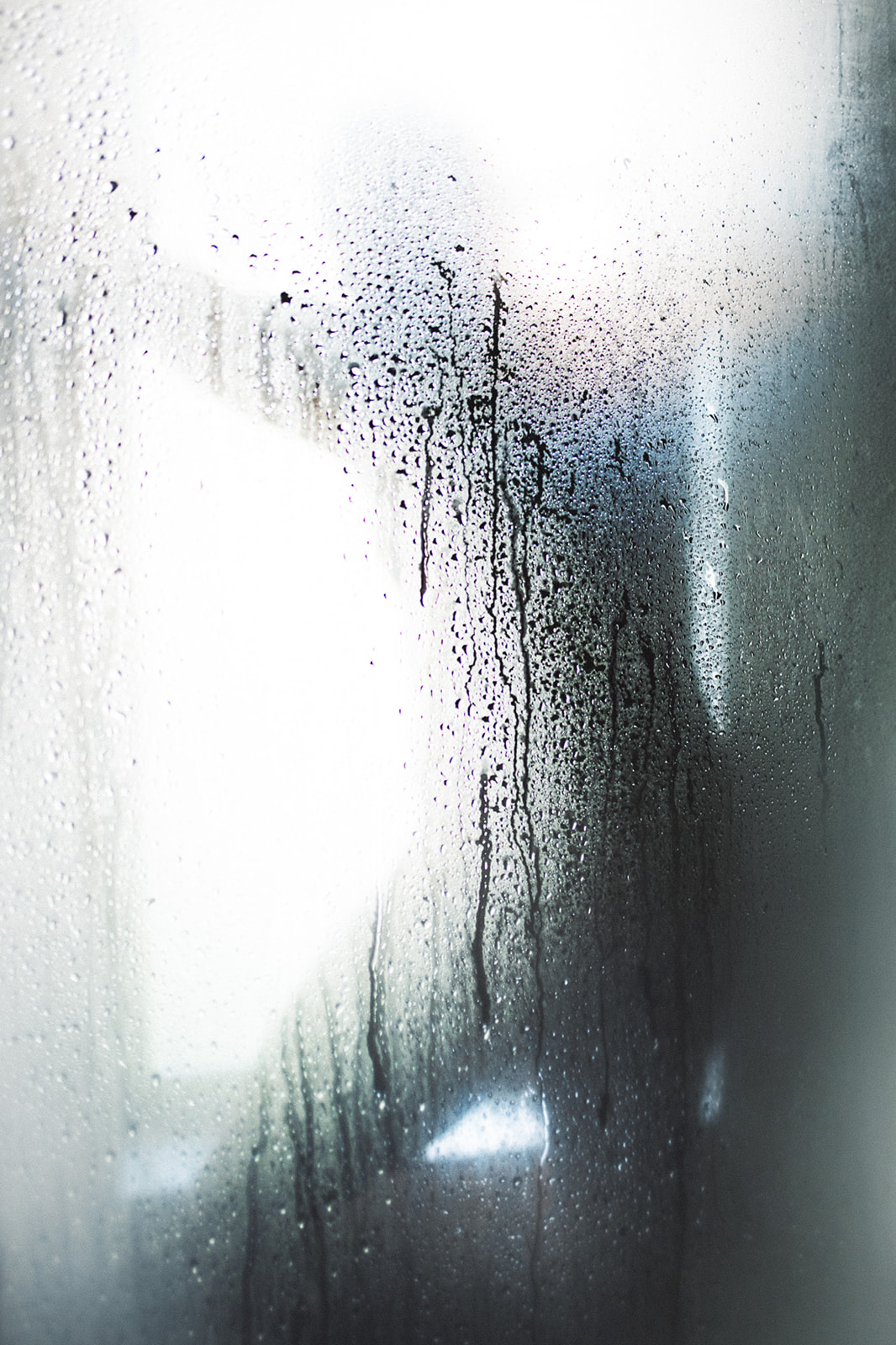 A silhouette of a man in a steamy shower