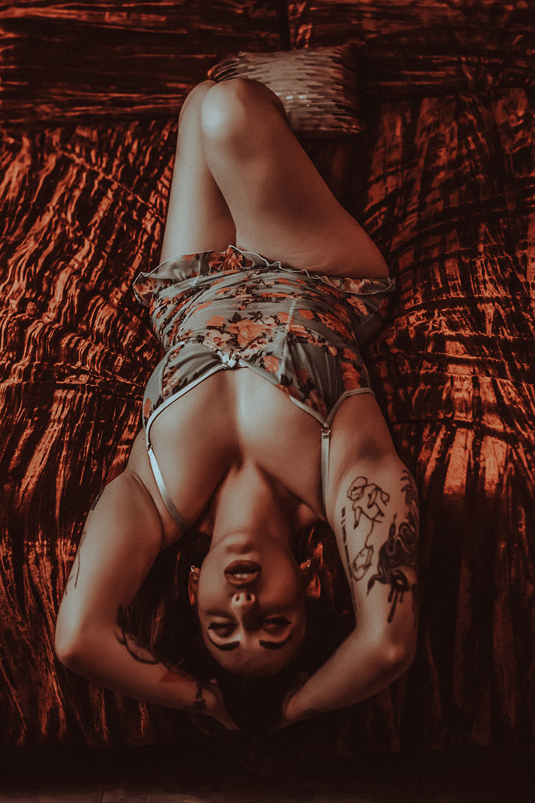 A look down at a woman laying across a bed with her head and arms hanging off in a coset after finding botox in Kalispell