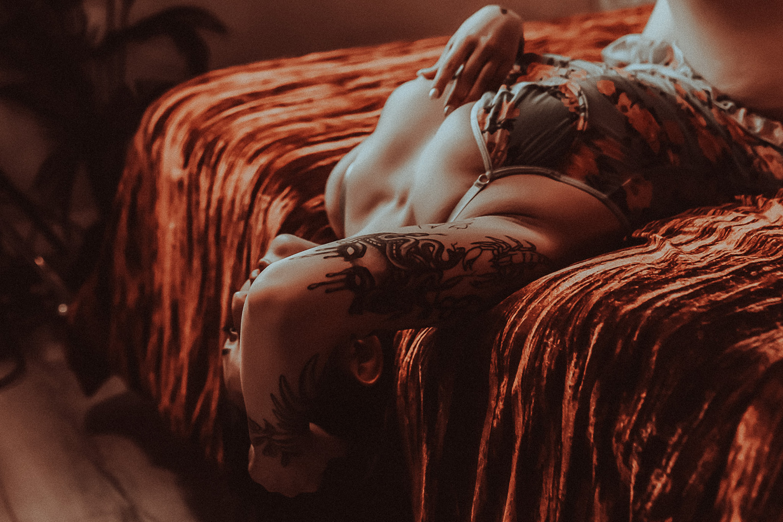 A woman lays back on a bed in a corset after finding great botox in Kalispell