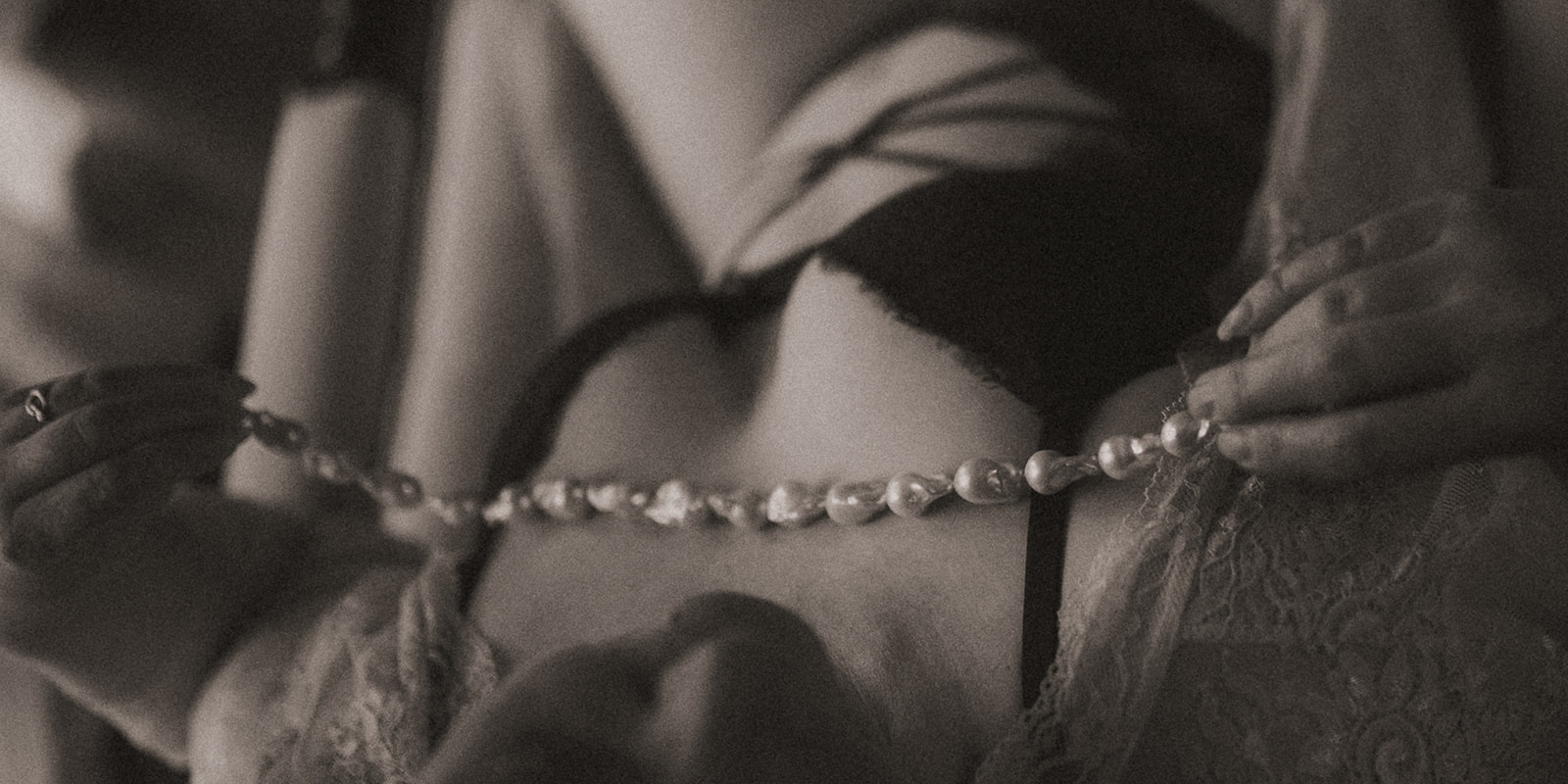 Details of a pearl necklace laying on the chest of a woman in her underwear after finding botox in Missoula